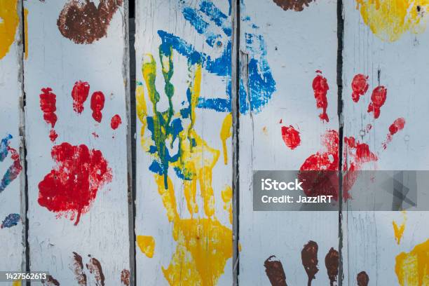 Wooden Background With Colored Prints Of Childrens Palms Stock Photo - Download Image Now