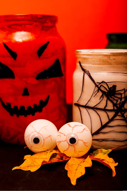 istock Halloween composition of eyes, pumpkin and a jar with a spider 1427564623