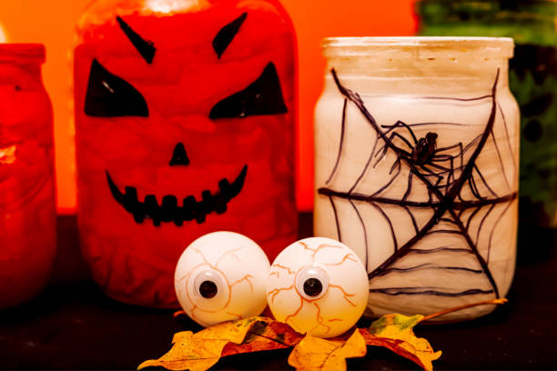 istock Halloween composition of eyes, pumpkin and a jar with a spider 1427564751
