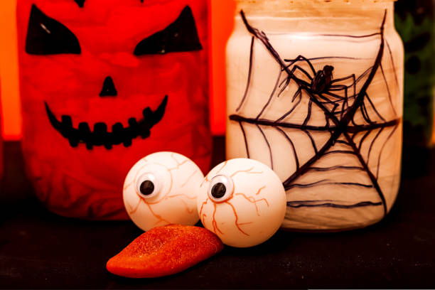 istock Halloween composition of eyes, pumpkin and a jar with a spider 1427564864