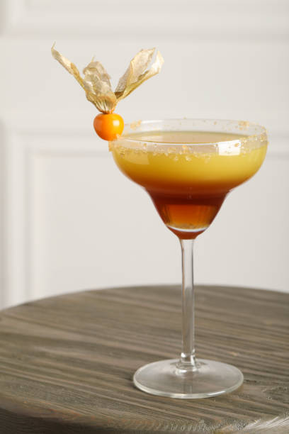istock Refreshing cocktail decorated with physalis fruit on wooden table indoors 1427565994