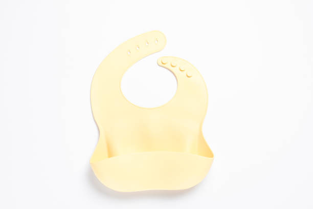 istock Beige silicone baby bib isolated on white, top view 1427566756