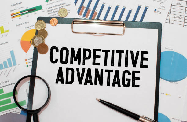 istock Closeup on businessman holding a card with text COMPETITIVE ADVANTAGE 1427567007