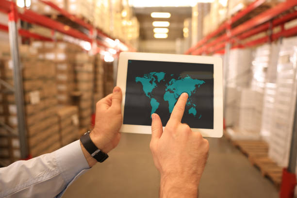 istock Man with tablet at warehouse, closeup. Wholesale business 1427569146