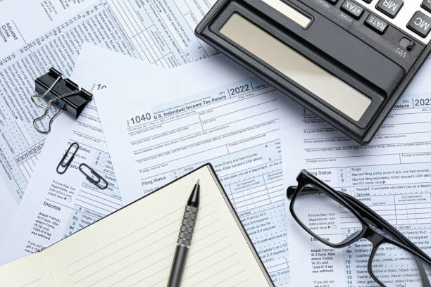 istock Calculator, pen, notebook and glasses on documents, flat lay. Tax accounting 1427569309