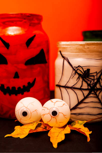 istock Halloween composition of eyes, pumpkin and a jar with a spider 1427569355
