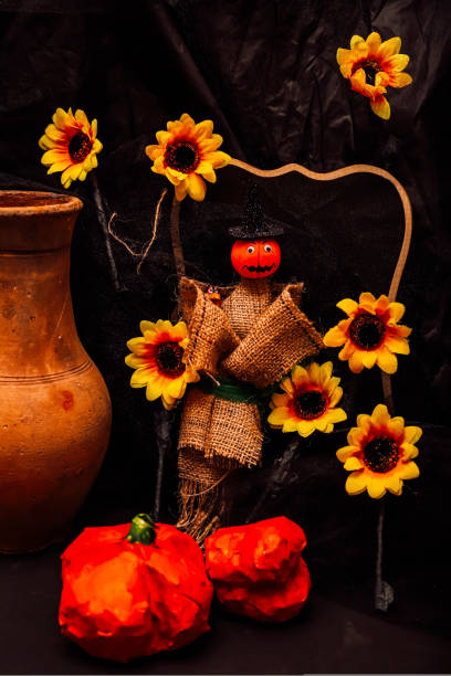 Composition of pumpkin and sunflowers for Halloween on a dark background. High quality photo