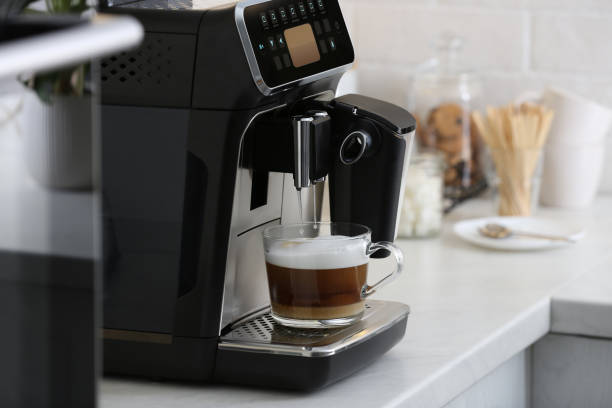 istock Modern electric espresso machine making coffee with milk on white marble countertop in kitchen 1427570071