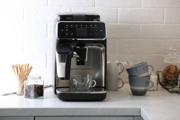 istock Modern electric coffee machine with glass cup on white marble countertop in kitchen 1427570073