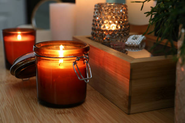 istock Lit candles on wooden dressing table indoors 1427571345