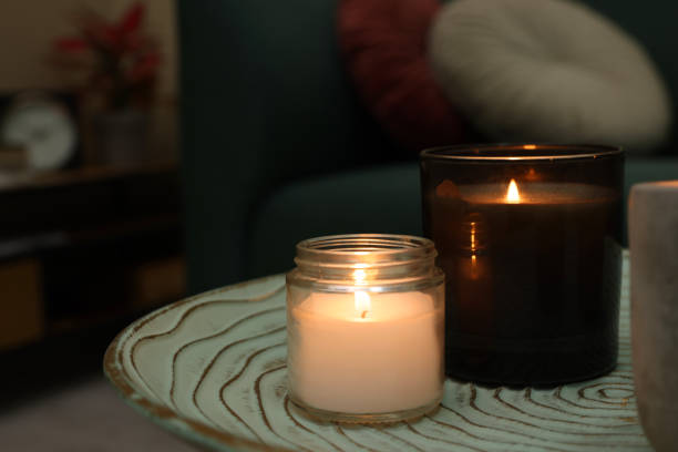 istock Lit candles on table in living room. Space for text 1427572062