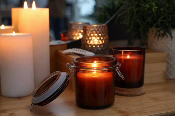 istock Lit candles on wooden dressing table indoors 1427572071