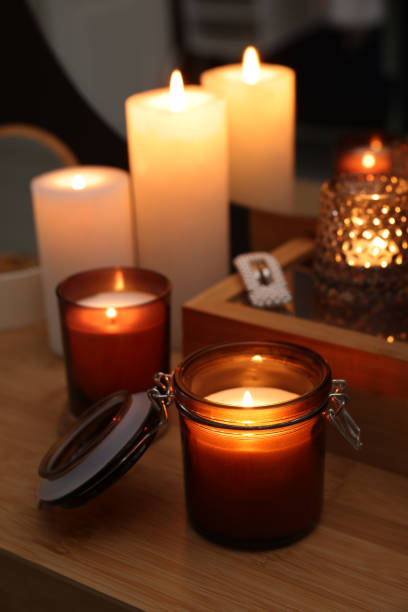 istock Lit candles on wooden dressing table indoors 1427572129