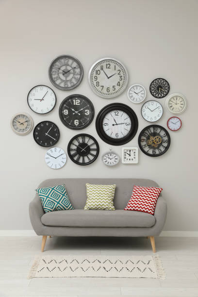 istock Sofa and many different clocks hanging on white wall in room 1427572723