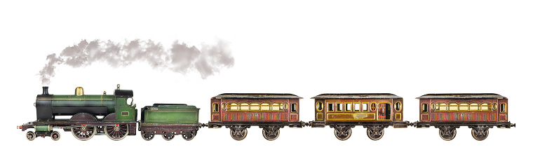 Vintage rusted and weathered toy passenger train with locomotive isolated on a white background