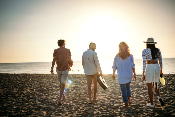 istock Group of friends walking on the beach 1427572762