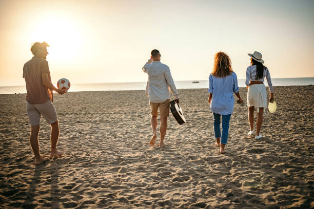 istock Group of friends walking on the beach 1427573291