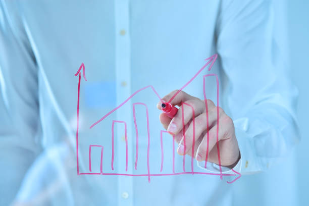 istock Businessman analyzes trade markets on transparent screen. 1427574282