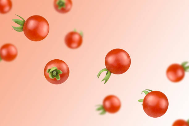 istock Levitation of cherry tomatoes on red background. 1427574804