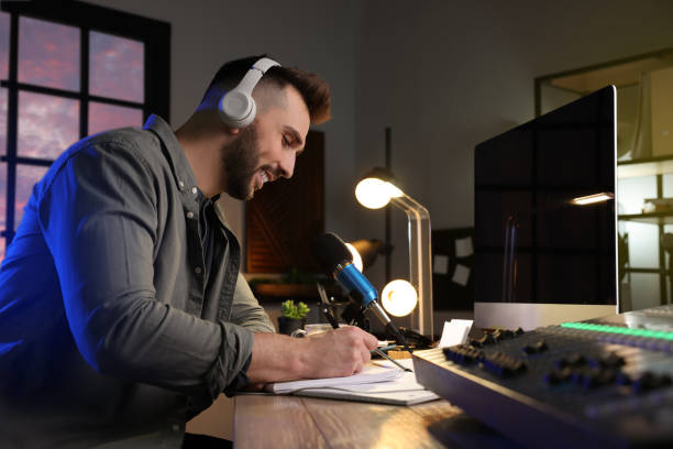 istock Man working as radio host in modern studio 1427576095