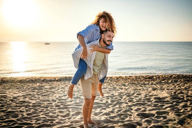 istock Young couple at the beach at sunset 1427576525