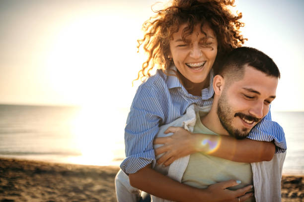 istock Young couple at the beach at sunset 1427576526