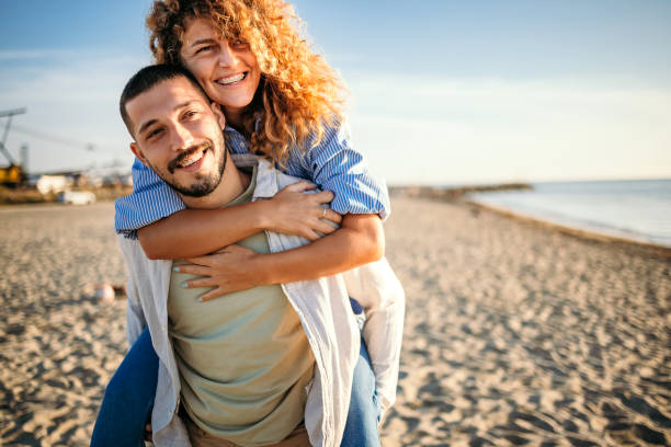 istock Young couple at the beach at sunset 1427577148
