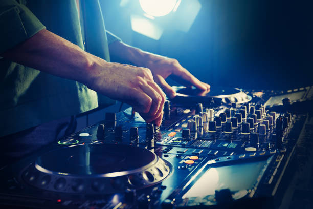 istock DJ creating music on modern console mixer in night club, closeup 1427577848