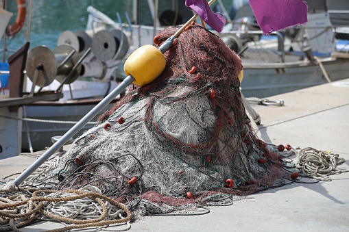 Fishing nets in the port. Fishing nets are laid out on the floor. Colorful fishing nets. Working fishing nets.