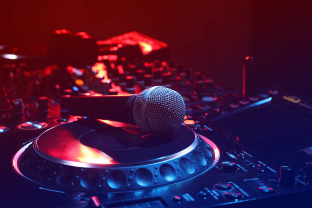 istock Closeup view of modern DJ controller with microphone on color background 1427577907