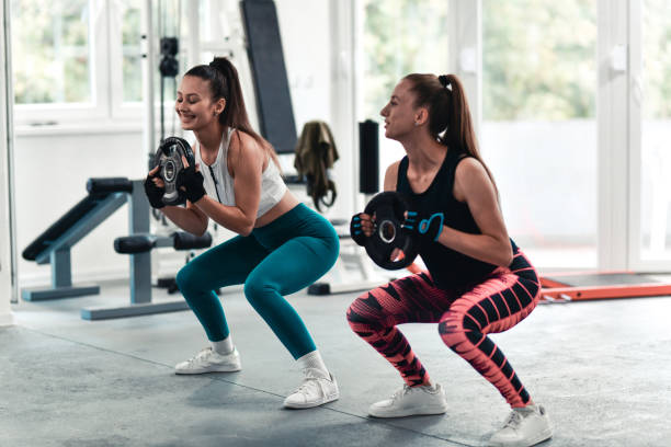 istock Strength Displayed By Female Athletes In Gym Workout Out With Dumbbells 1427577982