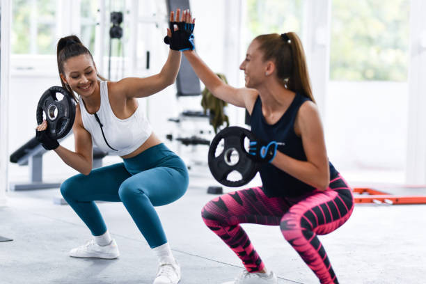 istock High Five For Successful Female Athletes Doing Weight Squats 1427578526