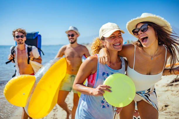 istock Young friends walking down a beach 1427579801