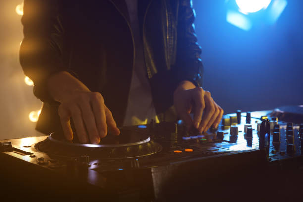 istock DJ creating music on modern console mixer in night club, closeup 1427579940