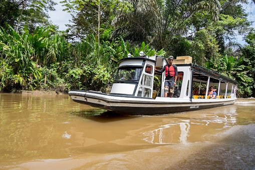 Limon, Costa Rica - September 11, 2022:Transport boat navigating the Tortuguero canal