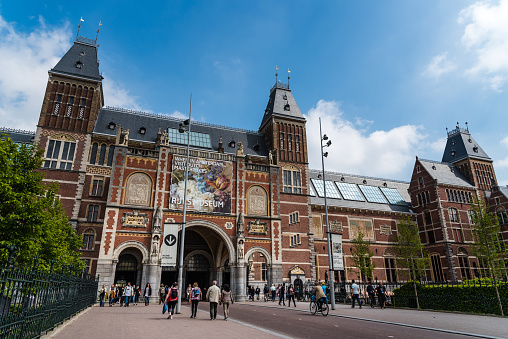 Amsterdam, Netherlands - May 7, 2022: Rijksmuseum (National state museum), a popular touristic destination in Amsterdam. B bright day of summer