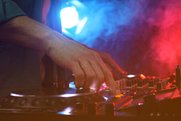 istock DJ creating music on modern console mixer in night club, closeup 1427580609