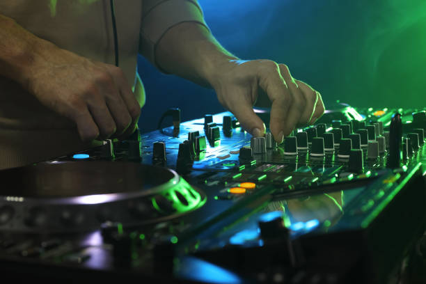 istock DJ creating music on modern console mixer in night club, closeup 1427580611