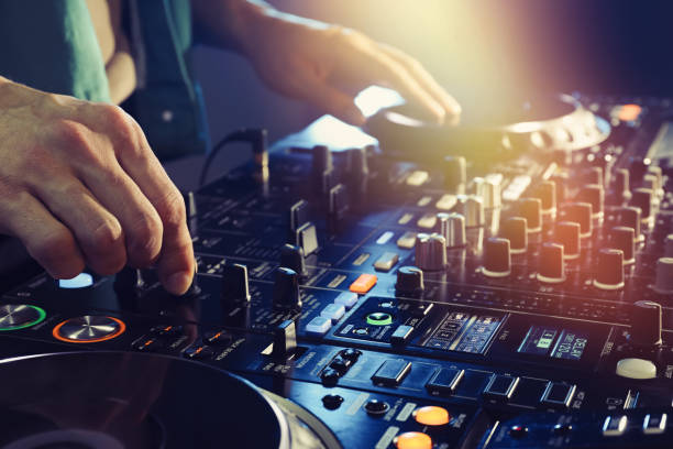 istock DJ creating music on modern console mixer in night club, closeup 1427580894