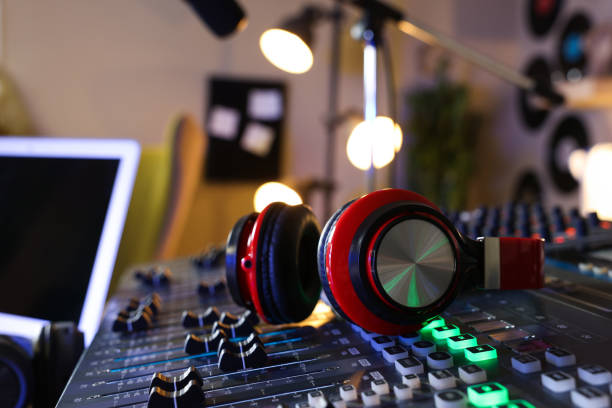 istock Headphones on professional mixing console in radio studio 1427581124