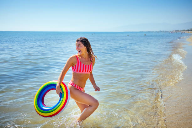 istock Woman on vacation playing at the beach 1427581400