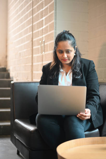 istock Business Woman working on laptop while siting at a cafe 1427582900
