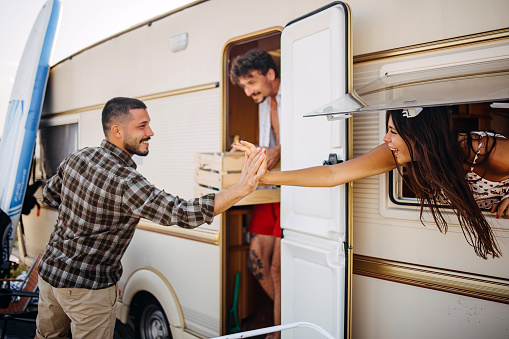 Group of friends camping together set up lunch