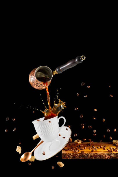 istock Falling coffee cup. Cup of coffee splashes while falling. Splash in white coffee cup. 1427589444