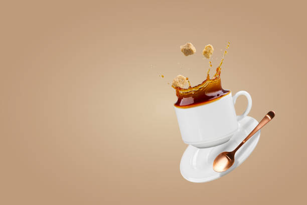 istock Falling coffee cup. Cup of coffee splashes while falling. Splash in white coffee cup. 1427589537