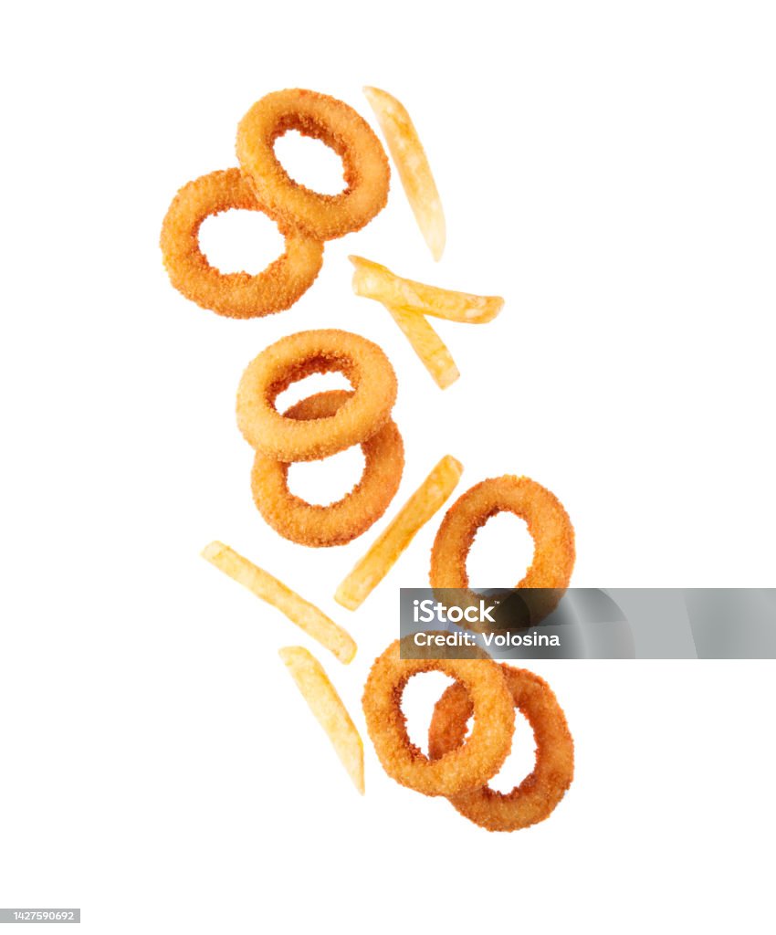 Flying fried potatoes and onion rings. Fast food Flying fried potatoes and onion rings close up on white backgrounds.Fast food Onion Ring Stock Photo