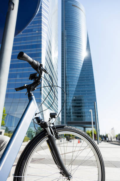 electric bicycle in front of office towers in the big city