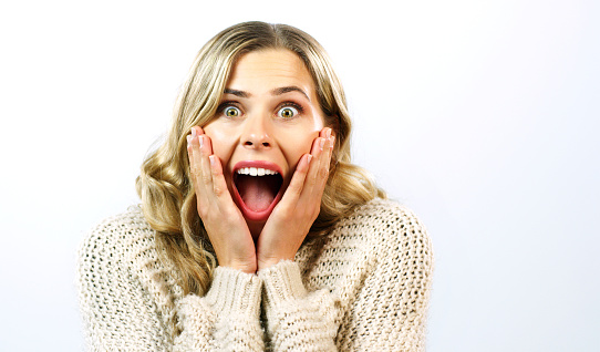 Wow, surprise and winner woman face and experience of winning, sale announcement or discount deal. Portrait of a happy, excited and omg facial gesture of a female with a studio white background