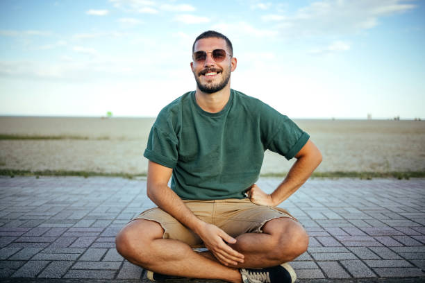 Portrait of a man sitting on a skateboard