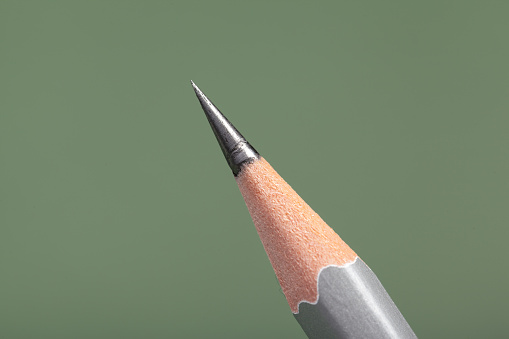 Black pencil isolated on white background. Close up image.